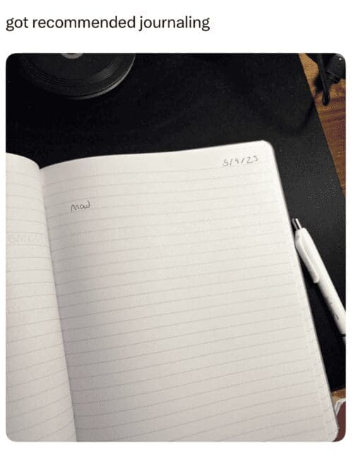 Open notebook dated “5/14/23” with a single word “Mad” written; pen beside it.