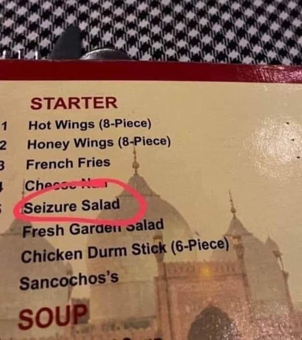 A funny restaurant menu with a very unfortunate typo, offering a "Seizure Salad" instead of the classic Caesar salad.