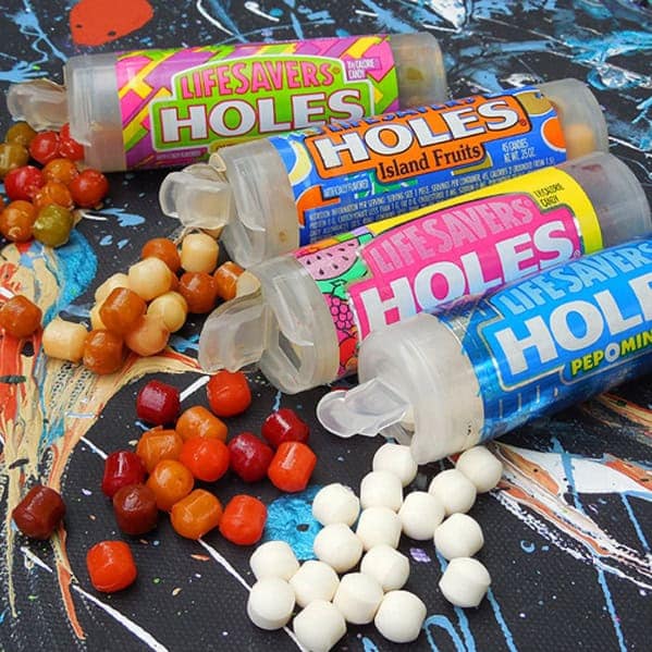 Several nostalgic plastic tubes of the popular 1990s discontinued candy, Life Savers Holes, in various fruit flavors.