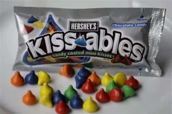 A silver bag of the discontinued Hershey's Kissables, showing the colorful, candy-coated miniature Hershey's Kisses.