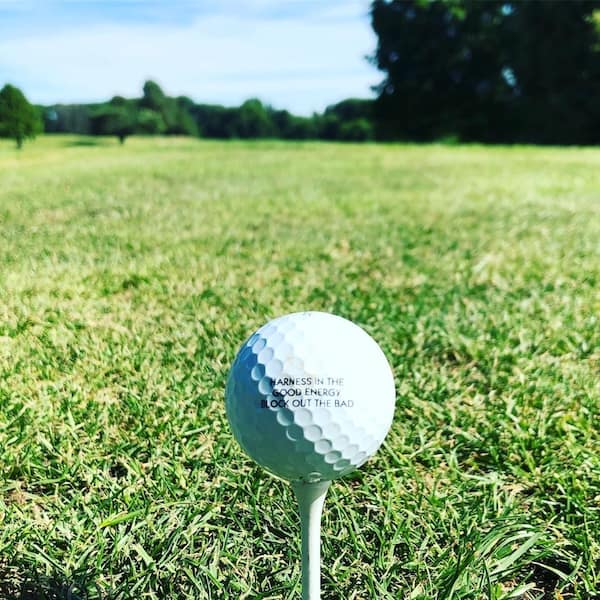A found golf ball with a very positive and motivational message about harnessing the good energy and blocking out the bad.