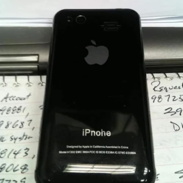 The back of a fake black Apple smartphone where the iconic brand name "iPhone" has been clearly and hilariously misspelled as "iPnohe."