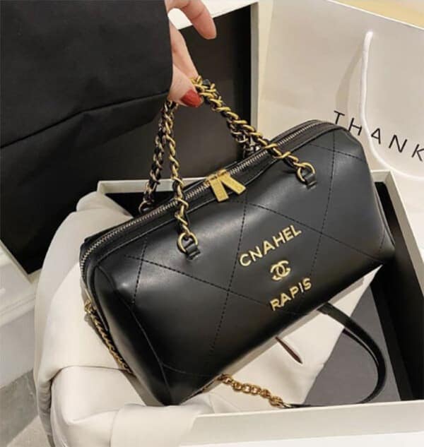 A knock-off black quilted luxury handbag where the "CHANEL PARIS" brand name has been hilariously misspelled as "CNAHEL RAPIS."