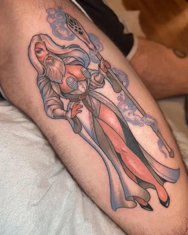 A detailed and unique leg tattoo of a gender-swapped, pin-up version of Gandalf from Lord of the Rings.