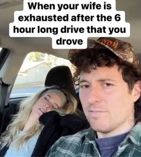 A funny and relatable selfie from a husband who is joking that his wife is completely exhausted from the long road trip that he drove himself.