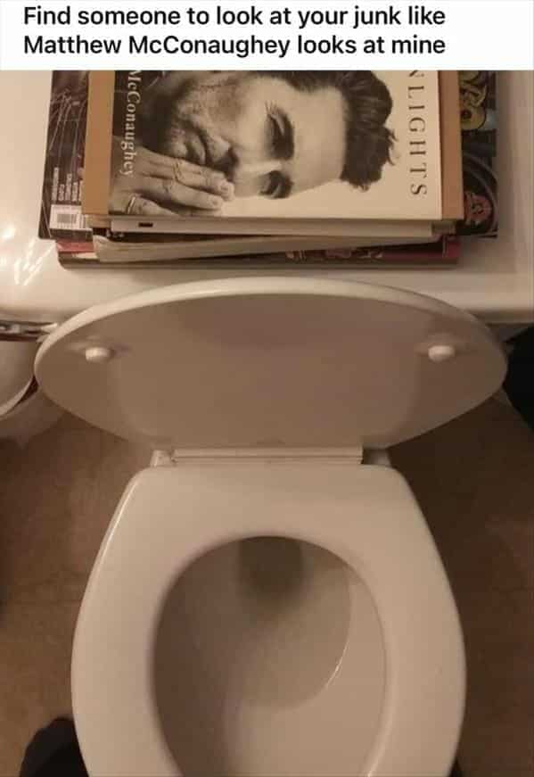 A hilarious photo that has been taken from the perspective of someone who is sitting on a toilet, where a Matthew McConaughey book cover makes it look like he is admiring you.