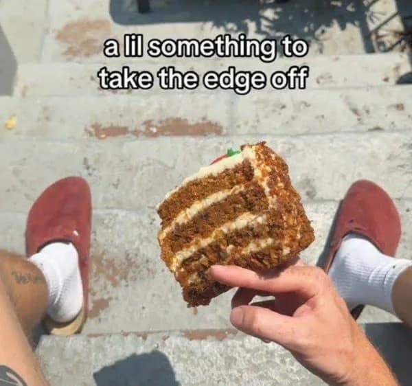 A funny and relatable meme of someone sitting on steps and eating a slice of cake to "take the edge off."