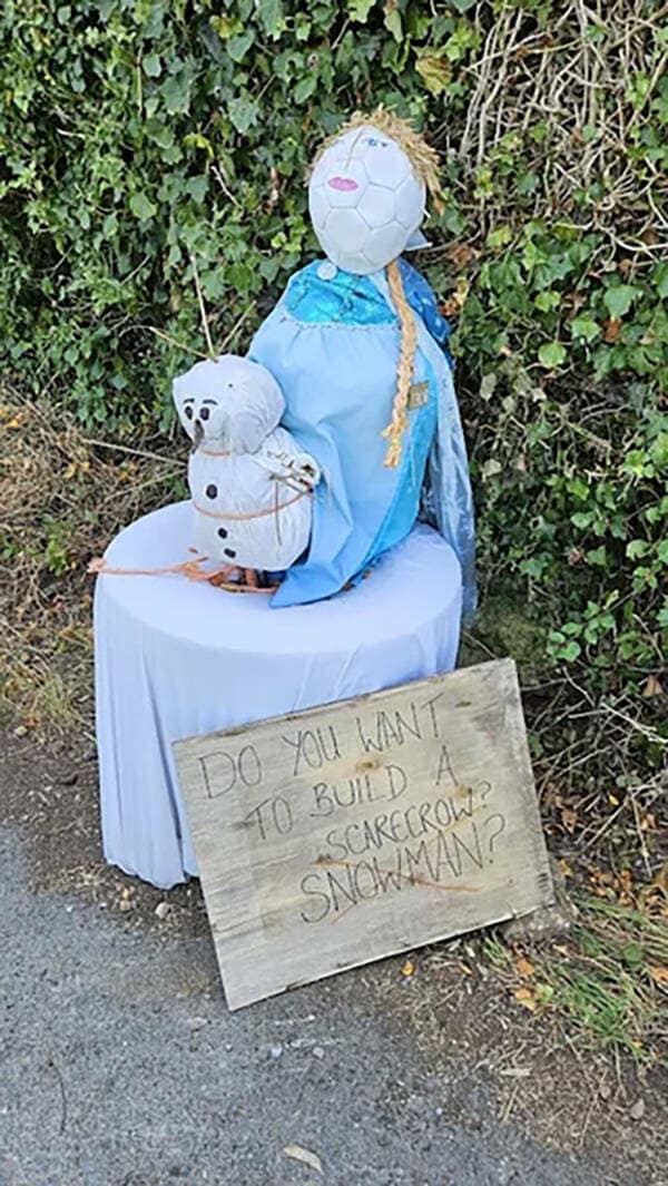 A funny and creative homemade scarecrow of the characters Elsa and Olaf from the Disney movie Frozen, with a clever pun on the famous song lyrics.
