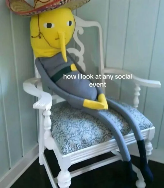 A funny and relatable introvert meme with Lemongrab from "Adventure Time" sitting awkwardly at a social event.
