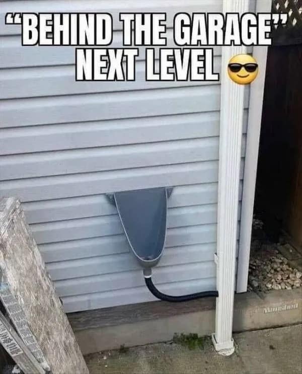 A strange photo of a house where the owner has done some DIY plumbing and has installed a public-style urinal on the outside wall of their garage, next to the downspout.