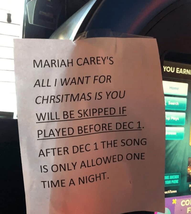 A funny sign at a bar limiting when Mariah Carey's "All I Want for Christmas Is You" can be played.