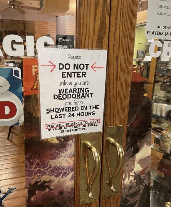 A funny sign at a game store requiring players to shower and wear deodorant before entering.