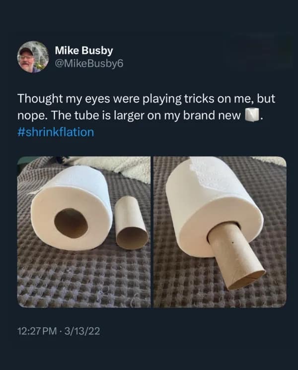 A photo demonstrating "shrinkflation" by showing how a new toilet paper roll has a much larger cardboard tube than the old one.
