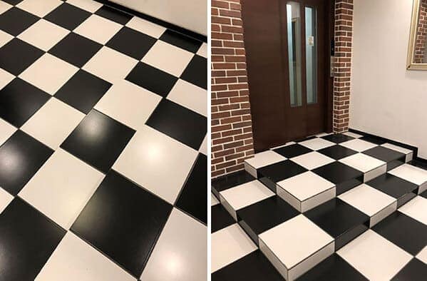 Black-and-white checkerboard steps camouflaged to look flat like the surrounding floor.