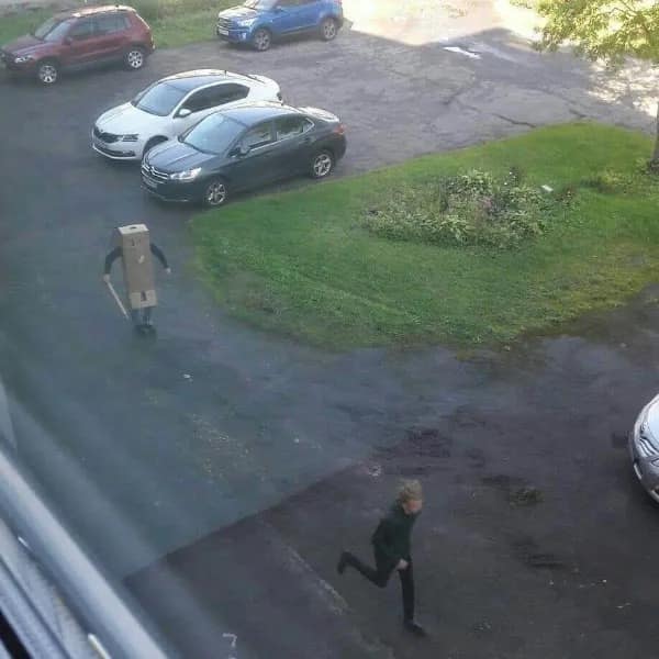 A meme dump photo of a person in a cardboard box costume chasing another person.