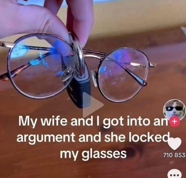 A funny photo from a TikTok video of a pair of glasses that has been locked with a small padlock through the nose bridge after an argument between a husband and wife.