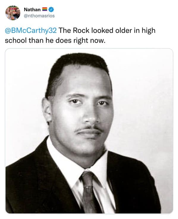 A viral reply tweet showing a high school yearbook photo of Dwayne "The Rock" Johnson looking like a full-grown adult man