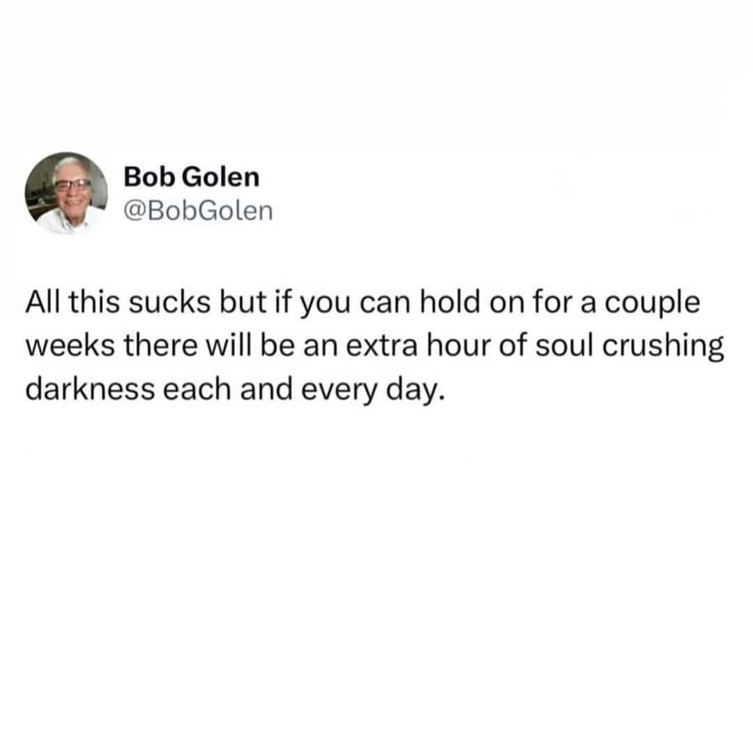 A funny seasonal depression meme tweet sarcastically looking forward to an extra hour of darkness.