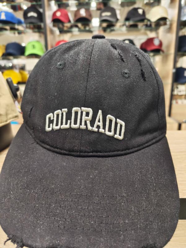 Black baseball cap embroidered “COLORAOD” instead of Colorado.