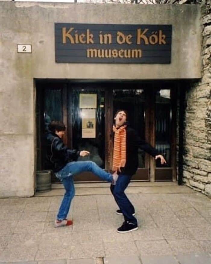 A weird photo with no context of someone being kicked in front of a museum.