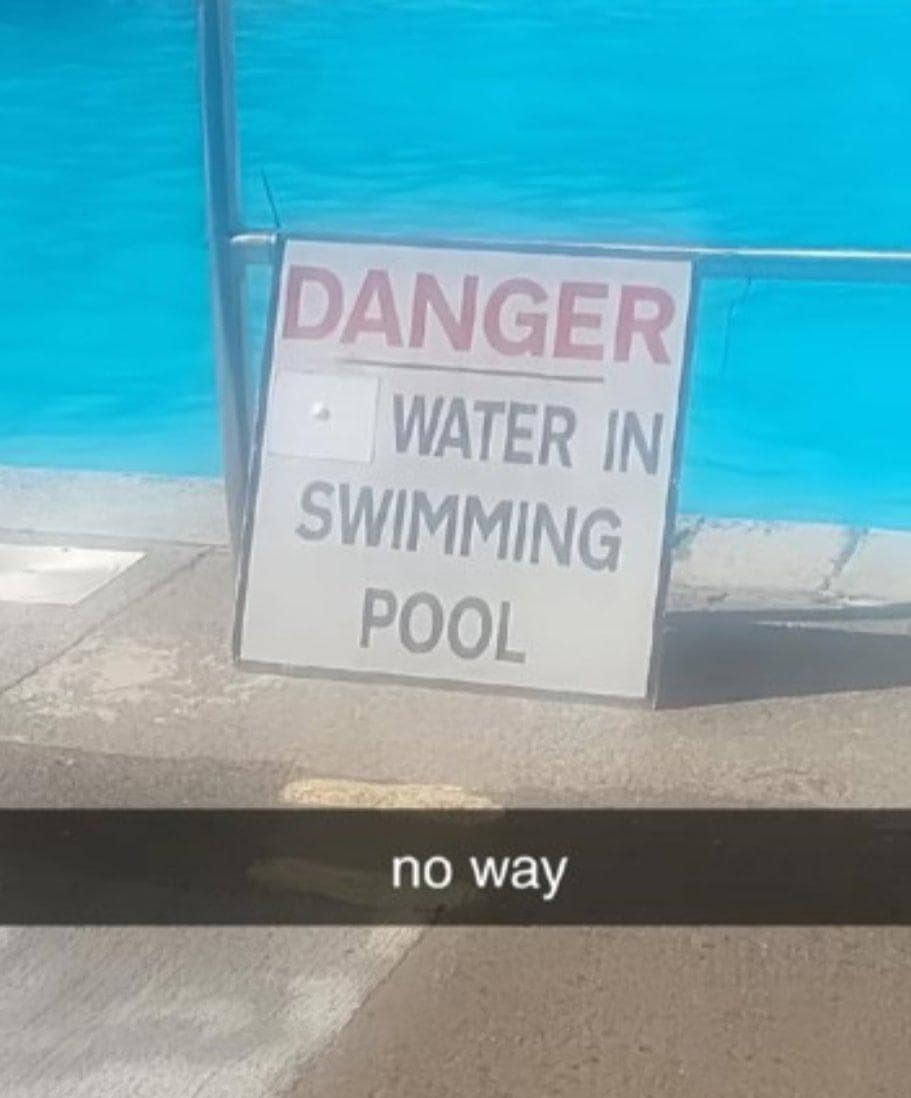 A funny example of wholesome vandalism on a pool sign that now reads "DANGER WATER IN SWIMMING POOL."