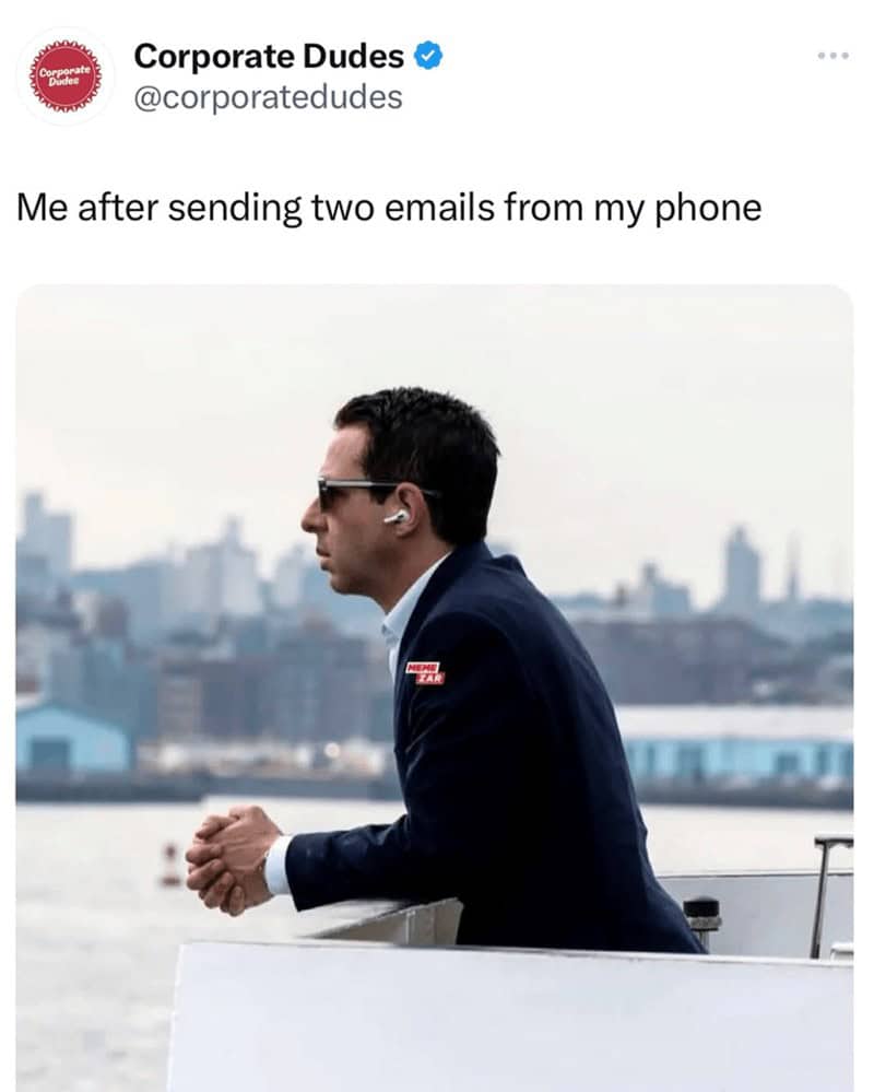Person in a suit with earbuds stares over the water, captioned “Me after sending two emails from my phone.”