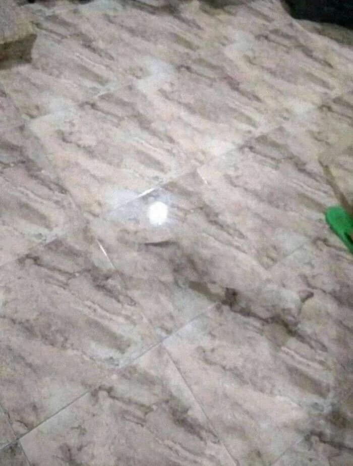 Confusing glitch in the matrix optical illusion where a floor tile seems to be missing or glowing strangely