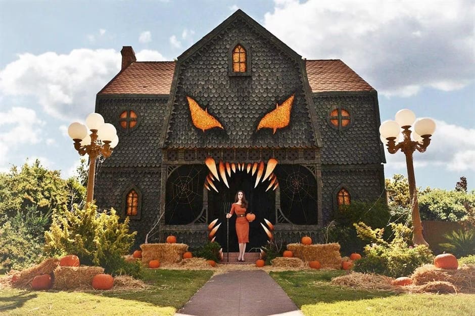 An amazing halloween house transformed into a giant monster face with glowing eyes and sharp teeth