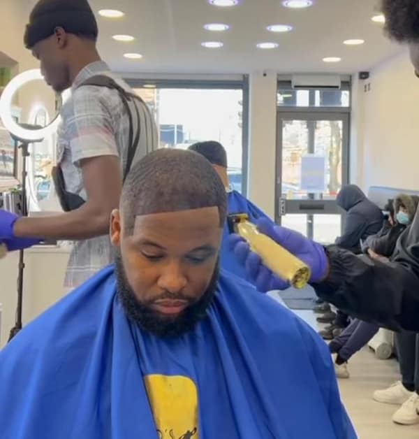 One of the most viral bad haircuts, featuring a man getting a fake hairline sprayed on with hair fibers