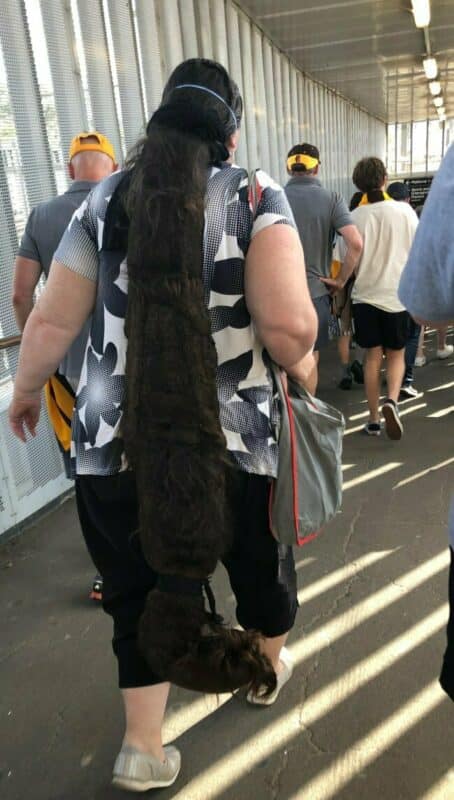 A woman with one of the most extreme bad haircuts, an incredibly long and matted ponytail.
