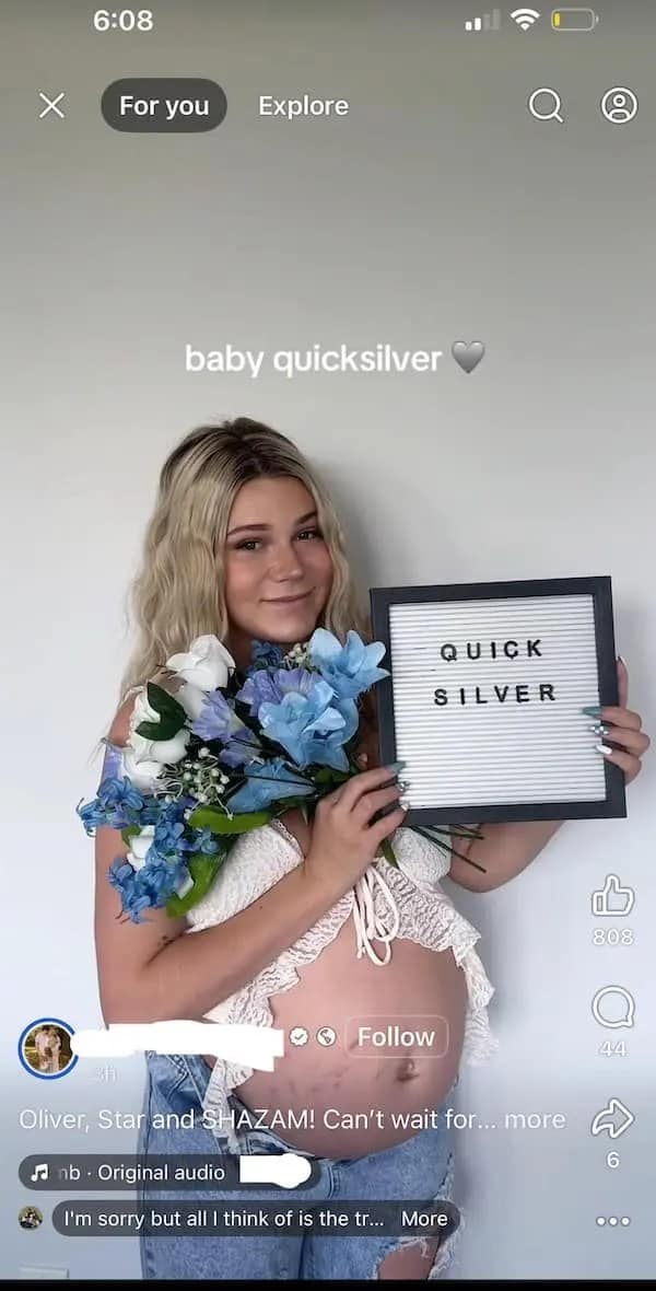 A pregnant woman holding a letterboard announcing her baby's weird name, "Quicksilver."