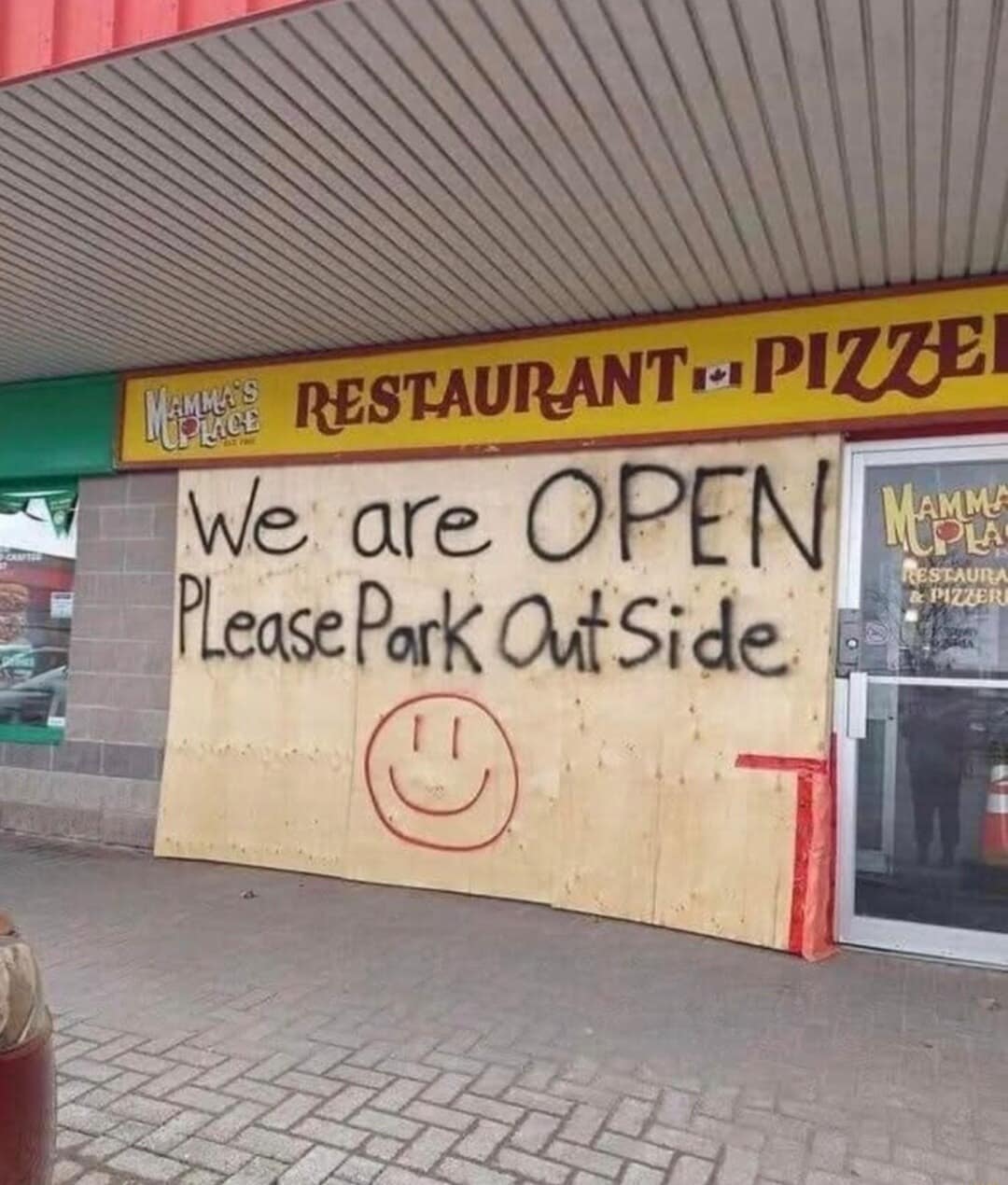 A classic meme of a boarded-up pizza place with a funny hand-painted sign.