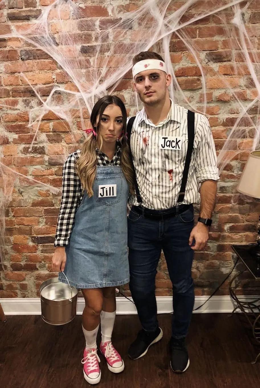 A creative couples halloween costume of Jack and Jill after they fell down the hill.