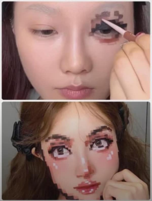 A cursed image of a makeup artist creating an optical illusion that makes her face look pixelated like a video game character.
