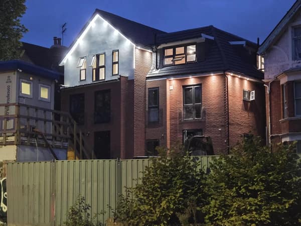 A home renovation fail showing a house with chaotic and mismatched exterior lighting that looks very ugly.