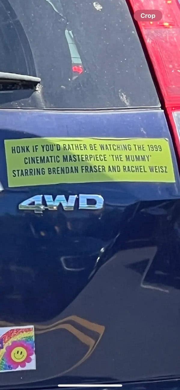 A very specific and funny bumper sticker asking people to honk if they'd rather be watching the 1999 movie "The Mummy."