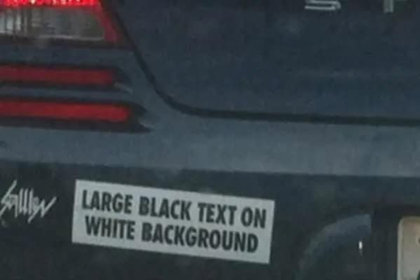 A meta and funny bumper sticker that literally describes itself: "LARGE BLACK TEXT ON WHITE BACKGROUND."