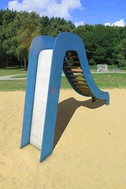 Epic fail photo showing a children's slide installed backwards, leading directly into the ladder steps.