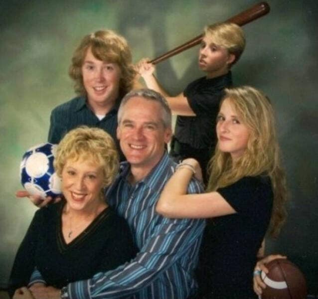 Awkward family photo where one sibling holds a baseball bat threateningly behind the others posing normally.