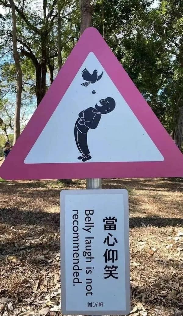 A funny pic of a park sign that warns against belly laughing due to bird poop.