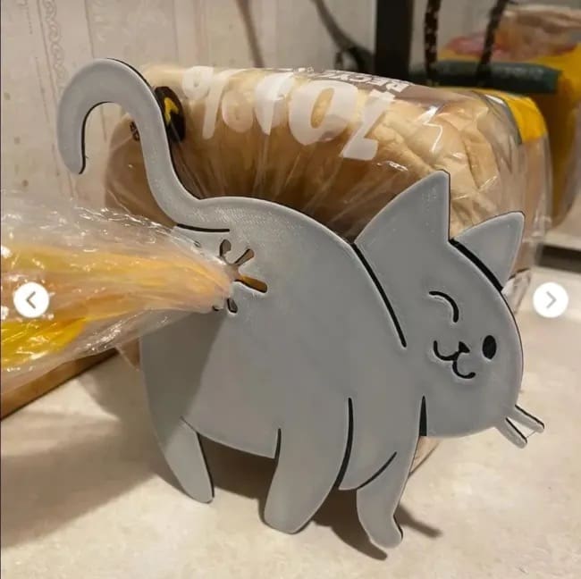 A novelty bread clip shaped like a cute gray cat, where the bag is secured through its butt.