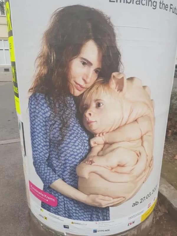 A deeply disturbing and weird art poster of a woman holding a fleshy pig-like creature.