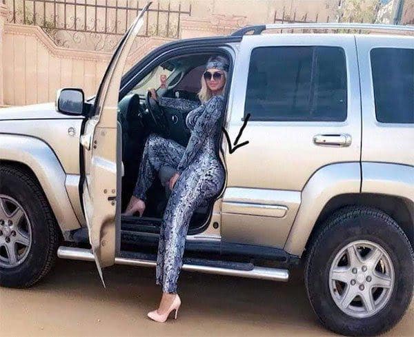 Classic funny photoshop fail showing a warped car door caused by editing the woman's body shape