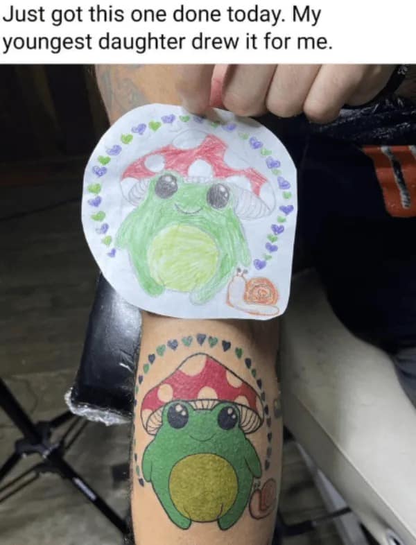 Wholesome photo comparing a daughter's cute drawing of a frog to the dad's identical finished tattoo.