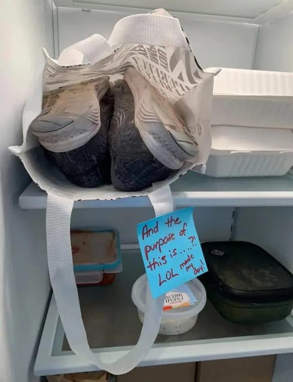 Funny pic of running shoes stored inside a reusable bag in a refrigerator next to food containers.