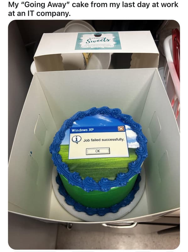 A funny "going away" cake decorated with the Windows XP background and a "Job failed successfully" error message.