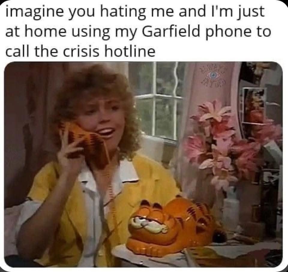 A funny meme about using a vintage, orange Garfield-themed telephone to call a crisis hotline.