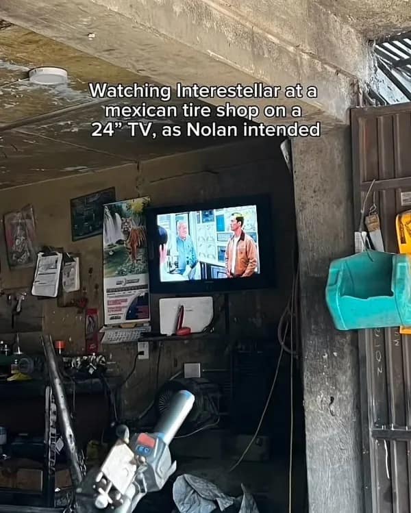A funny pic of the movie Interstellar playing on a small TV in a tire shop.
