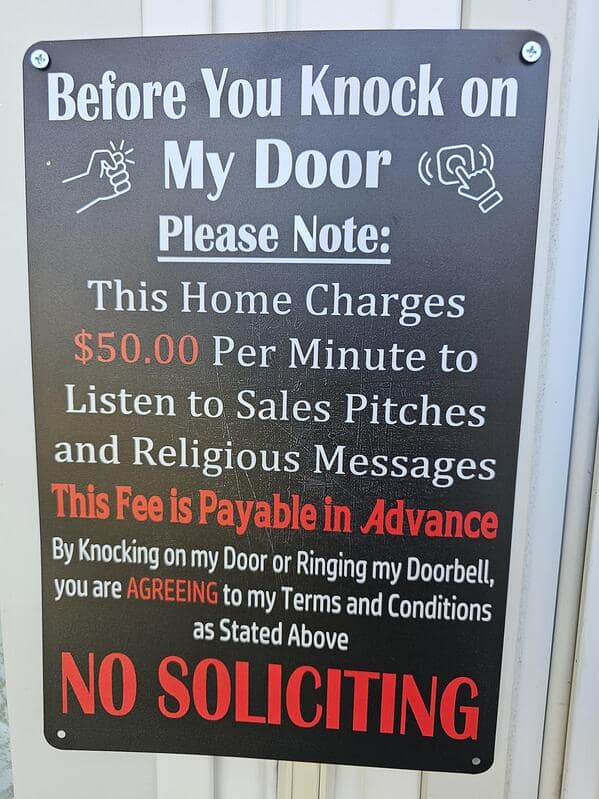 A no soliciting sign that charges a $50 per minute fee to listen to sales pitches.