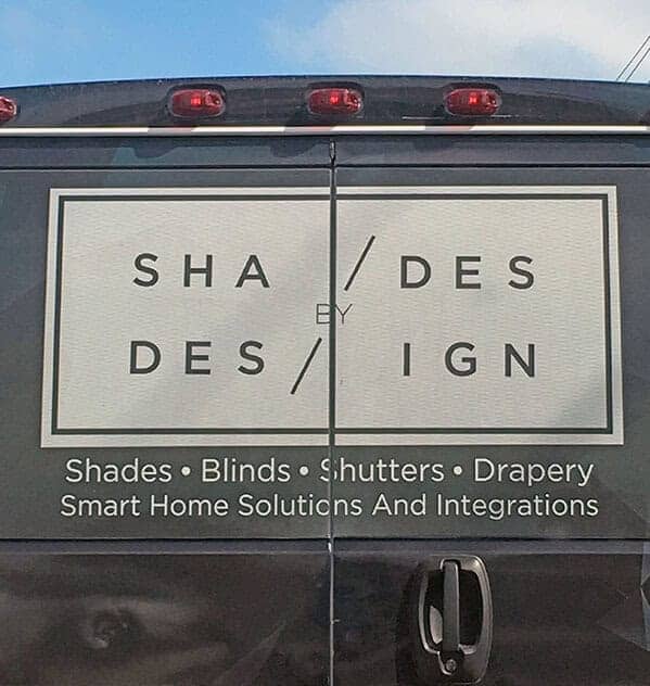 Funny sign design fail on the back of a van where doors split the company name awkwardly